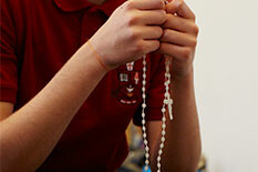 Picture of a person holding a rosary